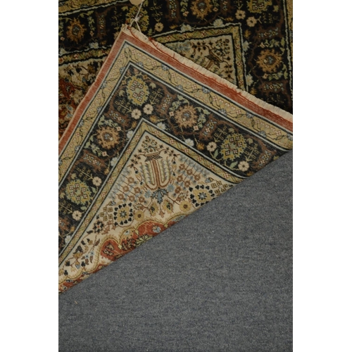 413 - A Persian design rug with floral decoration, 138cm x 90cm.