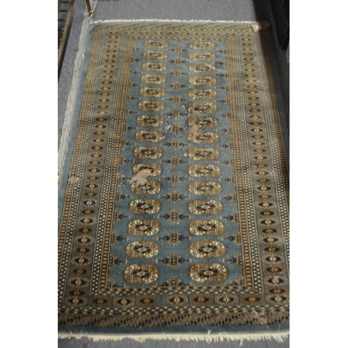 414 - A blue ground bokara style rug, 160cm x 97cm together with two small red ground Persian rugs, 125cm ... 