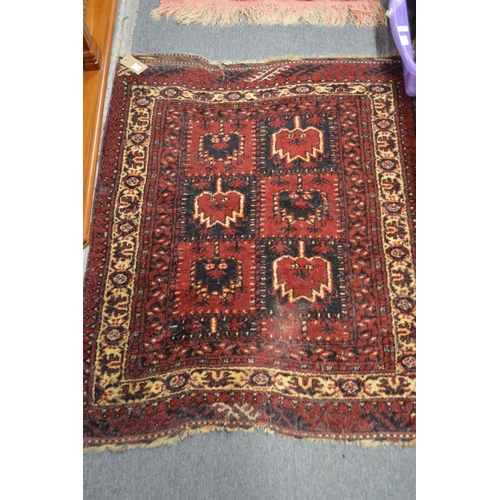 414 - A blue ground bokara style rug, 160cm x 97cm together with two small red ground Persian rugs, 125cm ... 