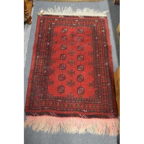 414 - A blue ground bokara style rug, 160cm x 97cm together with two small red ground Persian rugs, 125cm ... 