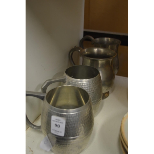 90 - Four pewter tankards.