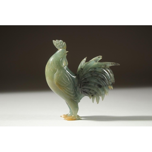 12 - A CARVED JADE FIGURE OF A COCKEREL on a wooden stand, 11cm high (on stand).