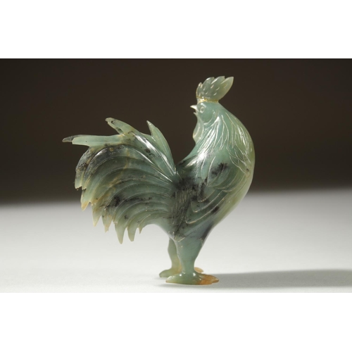 12 - A CARVED JADE FIGURE OF A COCKEREL on a wooden stand, 11cm high (on stand).