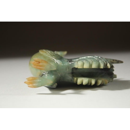 12 - A CARVED JADE FIGURE OF A COCKEREL on a wooden stand, 11cm high (on stand).