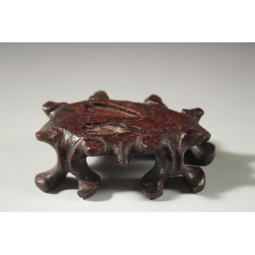 12 - A CARVED JADE FIGURE OF A COCKEREL on a wooden stand, 11cm high (on stand).