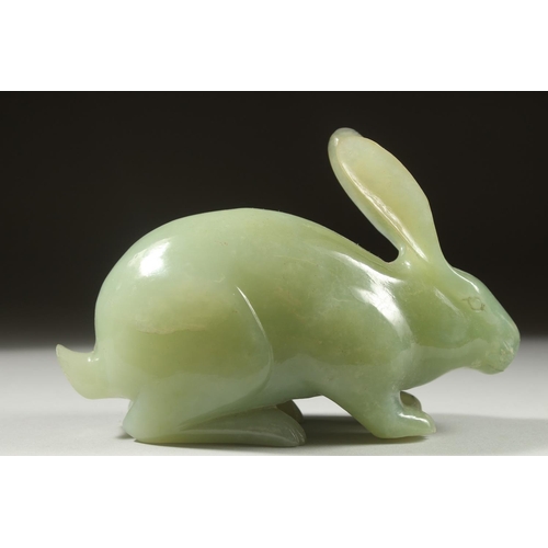16 - A LARGE CARVED JADE FIGURE OF A RABBIT on a fitted wooden base, 16cm long.