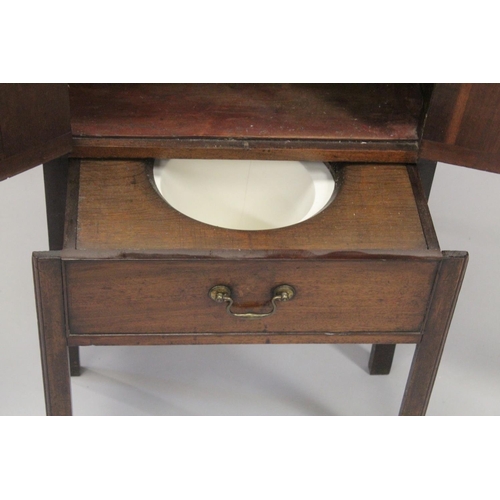 1004 - A GEORGE III MAHOGANY TRAY TOP BEDSIDE TABLE with hand apertures, the front with double panel doors ... 