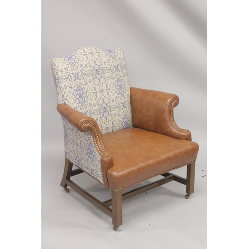 1010 - A GEORGE III MAHOGNAY GAINSBOROUGH ARMCHAIR with brass studs on straight legs with brass casters. 2f... 