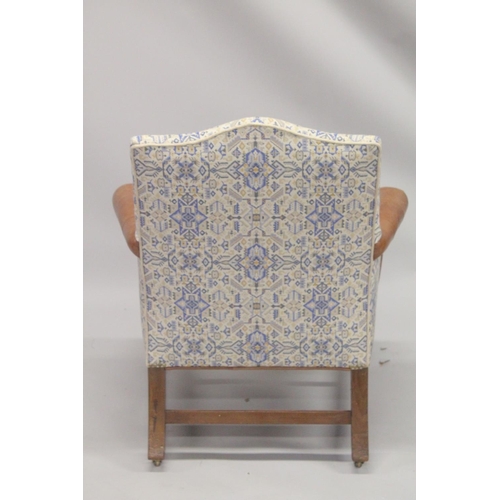 1010 - A GEORGE III MAHOGNAY GAINSBOROUGH ARMCHAIR with brass studs on straight legs with brass casters. 2f... 