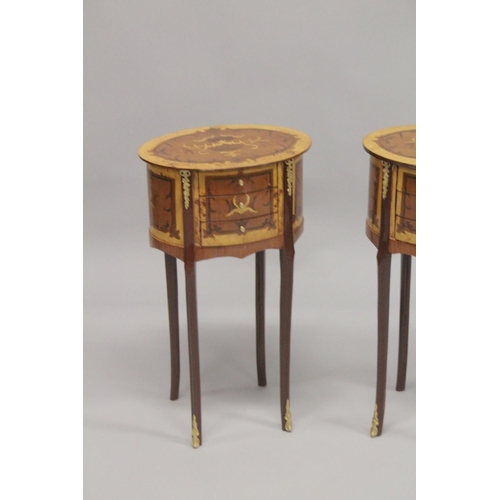 1023 - A PAIR OF LOUIS XVTH DESIGN OVAL BEDSIDE TABLES with three drawers. 2ft 4ins high.