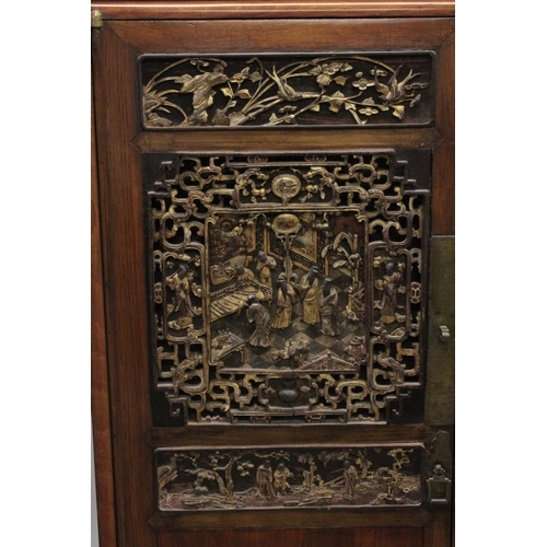 1025 - A 19TH CENTURY CHINESE CABINET with carved and pierced doors. 5ft high, 3ft 4ins wide.