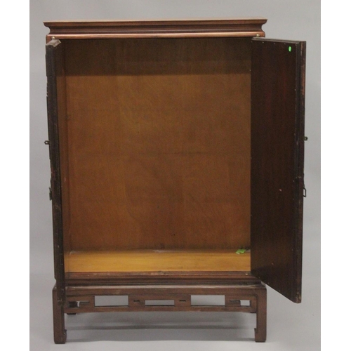 1025 - A 19TH CENTURY CHINESE CABINET with carved and pierced doors. 5ft high, 3ft 4ins wide.