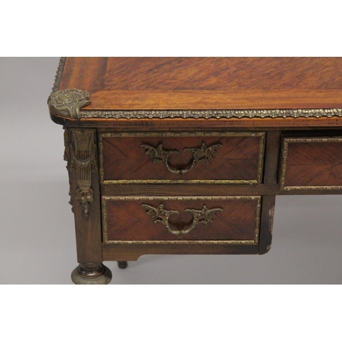 1027 - A LOUIS XVITH DESIGN WRITING TABLE with wooden top, five drawers on turned legs with ormolu mounts. ... 