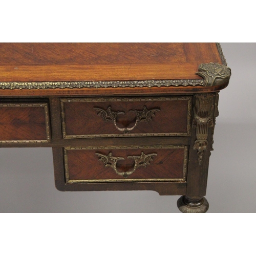 1027 - A LOUIS XVITH DESIGN WRITING TABLE with wooden top, five drawers on turned legs with ormolu mounts. ... 