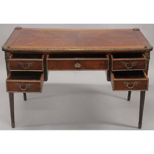 1027 - A LOUIS XVITH DESIGN WRITING TABLE with wooden top, five drawers on turned legs with ormolu mounts. ... 