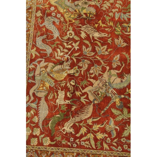 1039 - A VERY GOOD PERSIAN SILK HUNTING RUG red ground with figures of huntsmen on horseback, animals and t... 