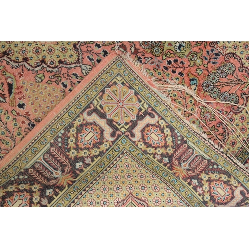 1040 - A PERSIAN PART SILK CARPET pink ground with sylised floral decoration within a similarly border. 210... 