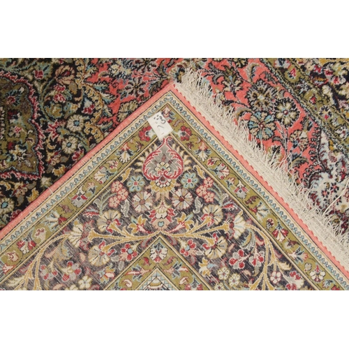 1041 - A PERSIAN PART SILK CARPET pink ground with sylised floral decoration within a similarly border. 210... 