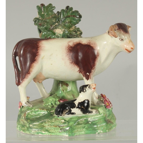 1065 - A STAFFORDSHIRE BOCAGE GROUP OF A COW AND CALF 5.5ins high.