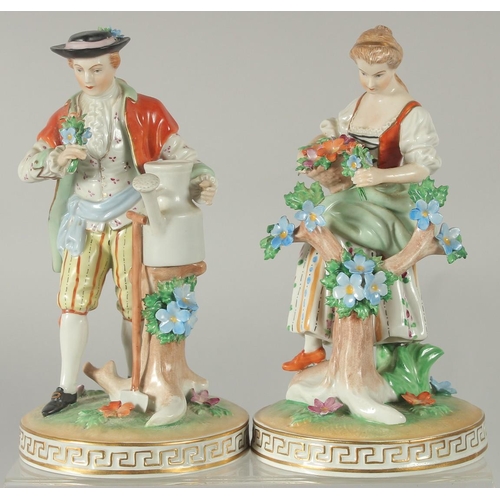 1071 - A PAIR OF SITZENDORF PORCELAIN FIGURES of a man with a watering can and a young lady with a basket o... 