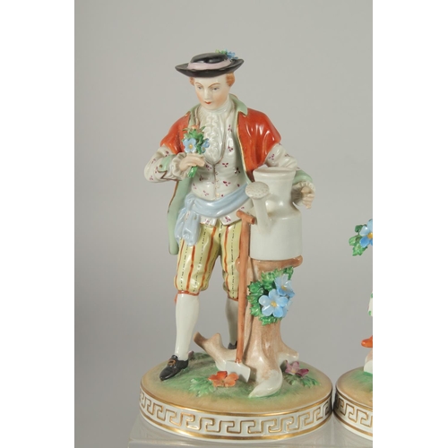 1071 - A PAIR OF SITZENDORF PORCELAIN FIGURES of a man with a watering can and a young lady with a basket o... 