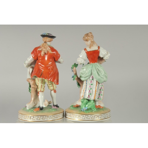 1071 - A PAIR OF SITZENDORF PORCELAIN FIGURES of a man with a watering can and a young lady with a basket o... 