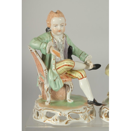 1072 - A PAIR OF SITZENDORF PORCELAIN FIGURES of a young man sitting legs crossed and a young lady. 5.5ins ... 