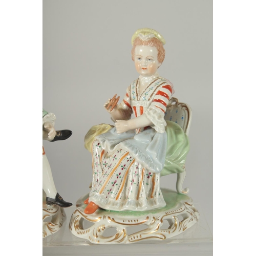 1072 - A PAIR OF SITZENDORF PORCELAIN FIGURES of a young man sitting legs crossed and a young lady. 5.5ins ... 