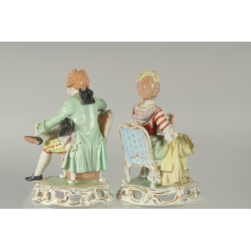 1072 - A PAIR OF SITZENDORF PORCELAIN FIGURES of a young man sitting legs crossed and a young lady. 5.5ins ... 