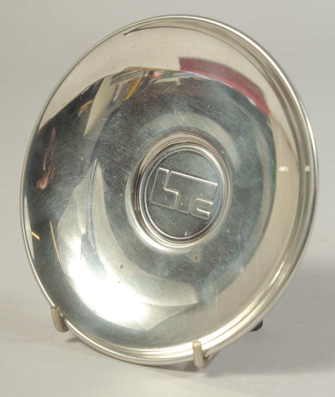 A CARTIER CIRCULAR PEWTER PRESENTATION PLATE. 4.75ins diameter boxed