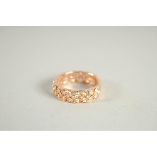 1658 - AN 18 CARAT ROSE GOLD AND DIAMOND THREE QUARTERS BANDED RING. Diamond 0.6 carat.