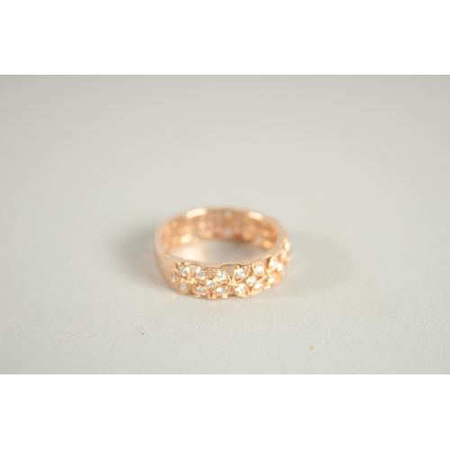 1658 - AN 18 CARAT ROSE GOLD AND DIAMOND THREE QUARTERS BANDED RING. Diamond 0.6 carat.