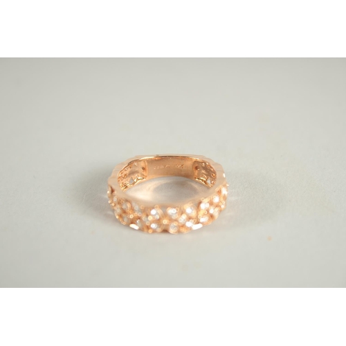 1658 - AN 18 CARAT ROSE GOLD AND DIAMOND THREE QUARTERS BANDED RING. Diamond 0.6 carat.