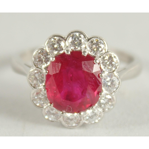 1659 - AN 18 CARAT WHITE GOLD,  RUBY AND DIAMOND CLUSTER RING. Ruby 3 carats +.