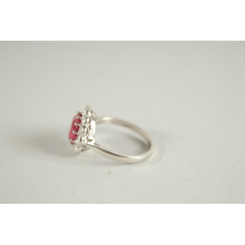 1659 - AN 18 CARAT WHITE GOLD,  RUBY AND DIAMOND CLUSTER RING. Ruby 3 carats +.