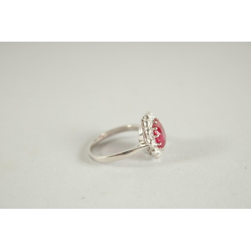 1659 - AN 18 CARAT WHITE GOLD,  RUBY AND DIAMOND CLUSTER RING. Ruby 3 carats +.