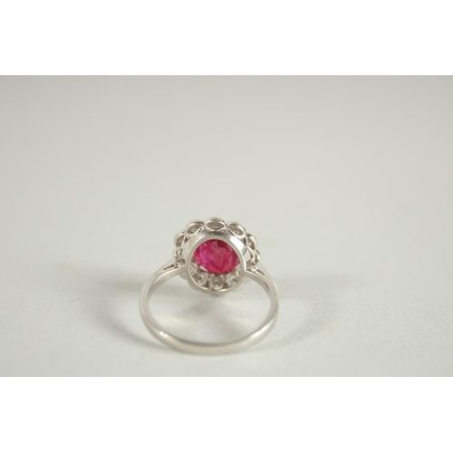 1659 - AN 18 CARAT WHITE GOLD,  RUBY AND DIAMOND CLUSTER RING. Ruby 3 carats +.