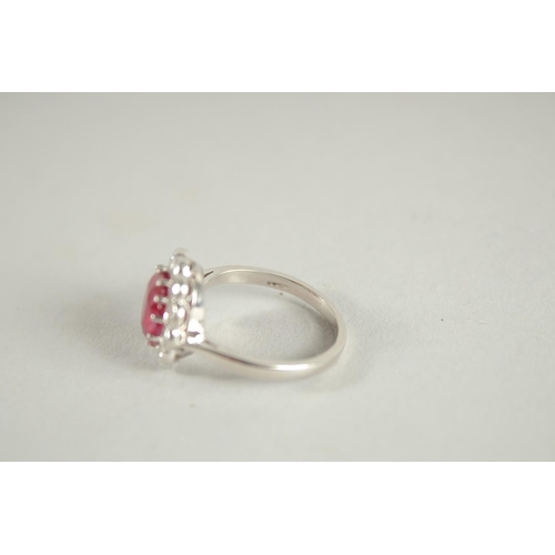 1659 - AN 18 CARAT WHITE GOLD,  RUBY AND DIAMOND CLUSTER RING. Ruby 3 carats +.