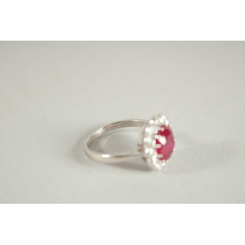 1659 - AN 18 CARAT WHITE GOLD,  RUBY AND DIAMOND CLUSTER RING. Ruby 3 carats +.