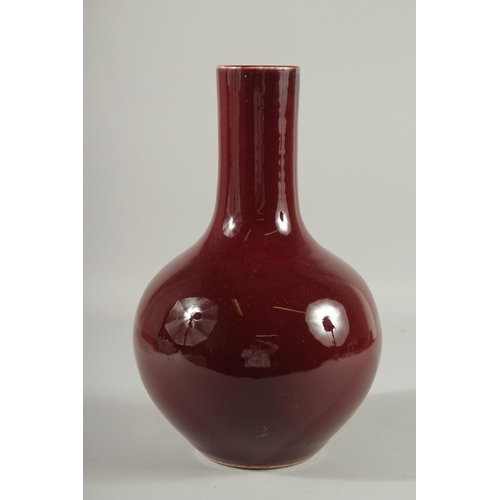 102 - A LARGE CHINESE OX BLOOD GLAZE PORCELAIN VASE, the base with six-character mark, 33.5cm high.