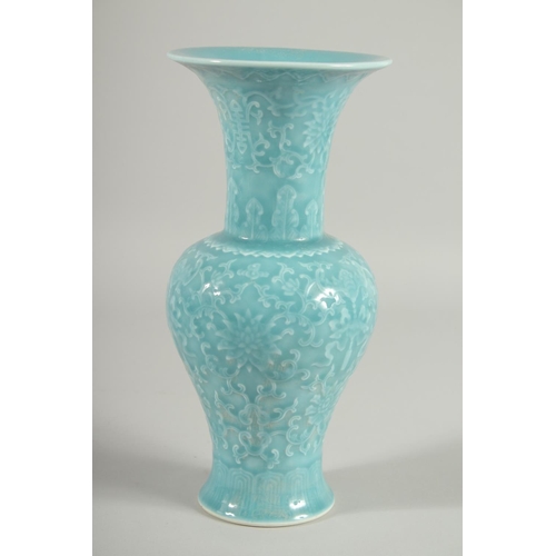 103 - A CHINESE POWDER BLUE GLAZE PORCELAIN VASE, with carved floral motifs and bats, 25.5cm high.