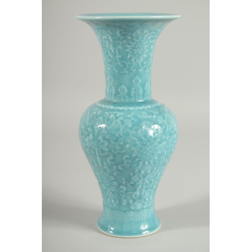 103 - A CHINESE POWDER BLUE GLAZE PORCELAIN VASE, with carved floral motifs and bats, 25.5cm high.