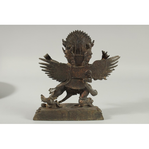 107 - A TIBETAN BRONZE FIGURE OF A THREE-HEADED DEITY, 24.5cm high.