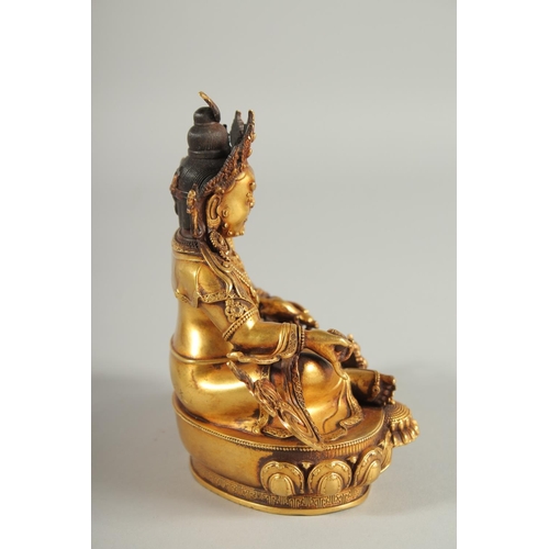 108 - A TIBETAN GILT ALLOY FIGURE OF A SEATED DEITY, 15cm high.