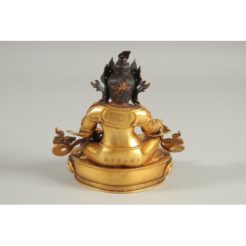 108 - A TIBETAN GILT ALLOY FIGURE OF A SEATED DEITY, 15cm high.