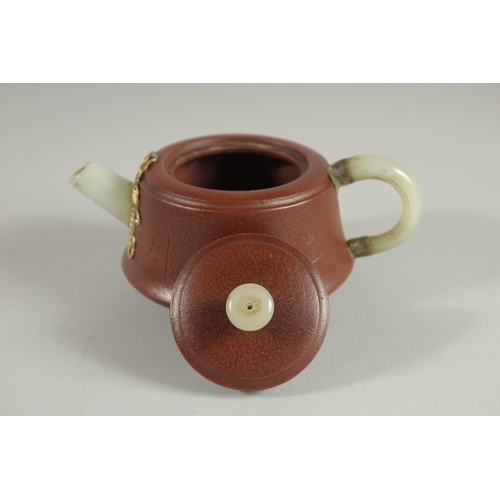 110 - A CHINESE YIXING TEAPOT WITH MOUNDED JADE HANDLE AND SPOUT, with impressed marks to base and inner l... 