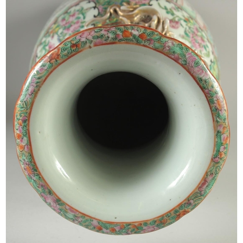 114 - A LARGE CHINESE CANTON FAMILLE ROSE PORCELAIN VASE, the neck with moulded chilong, painted with pane... 