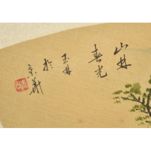 123 - A CHINESE FAN PAINTING OF A LANDSCAPE, framed and glazed, with script and red seal, fan 48cm wide.