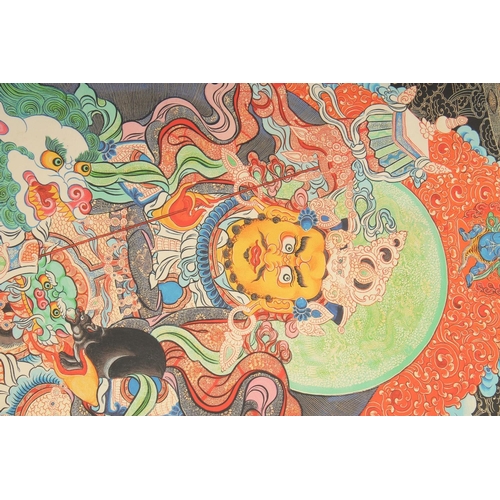 127 - A TIBETAN THANGKA, mounted on paper.