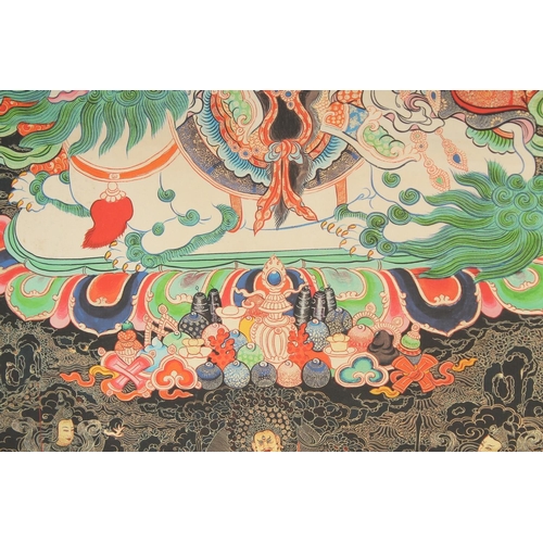 127 - A TIBETAN THANGKA, mounted on paper.